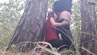 Two Girls Get Intimate Under A Tree During A Rainstorm